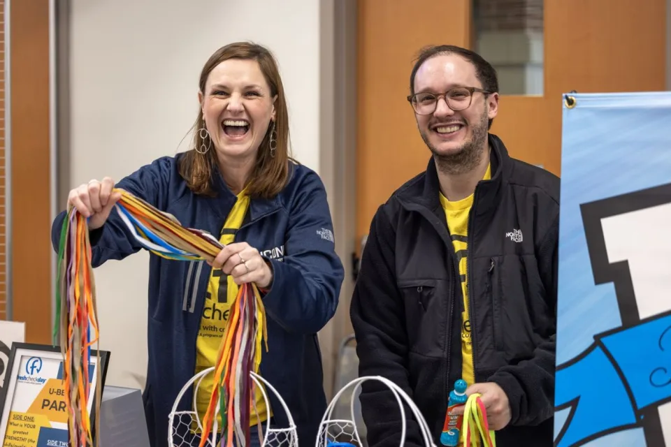 Advisors smiling at one of our Resource Fairs